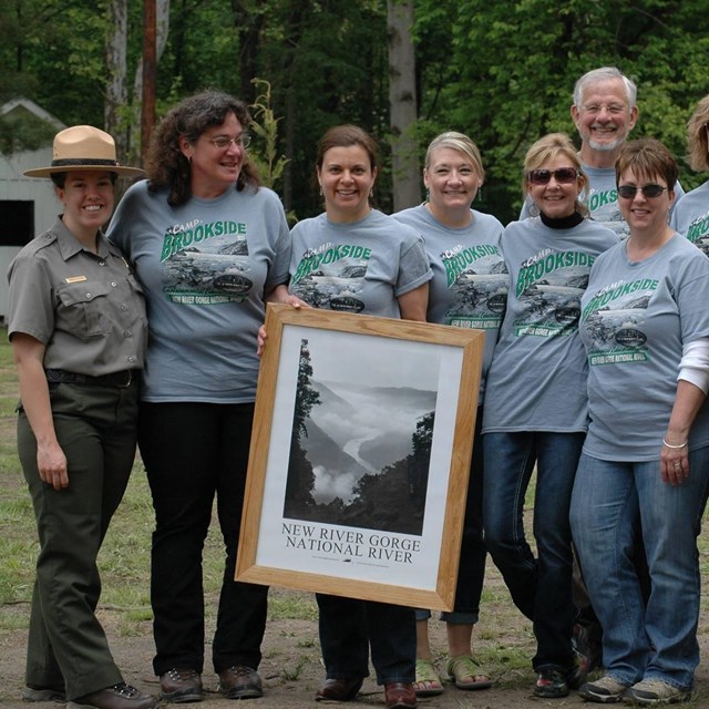 Freinds group members pose with a framed photo