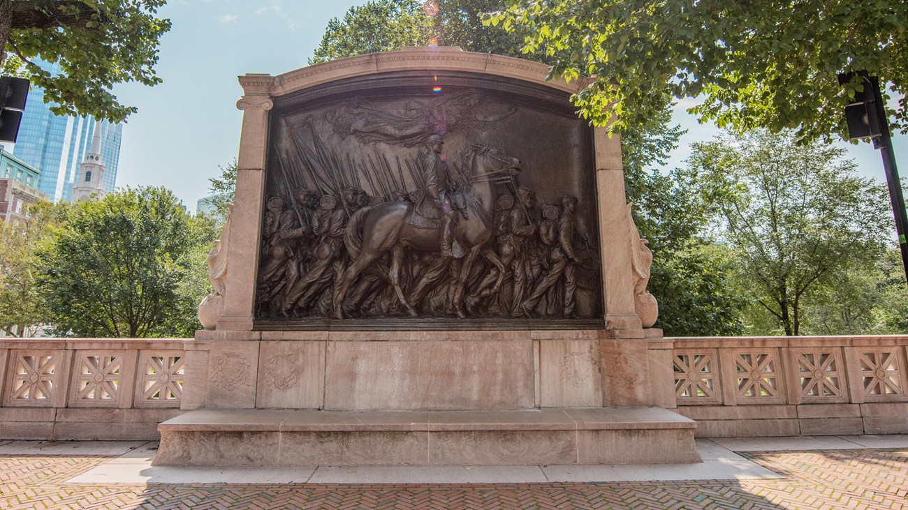 View of the bronze 54th Regiment and Robert Gould Shawn Monument on a sunny day