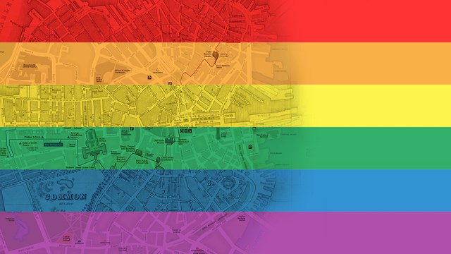 Rainbow flag imposed over cutaways of maps of downtown Boston.