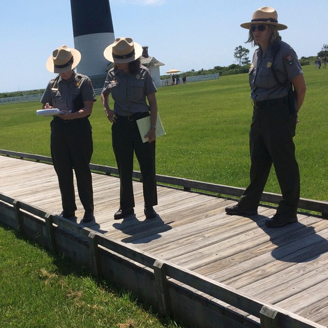 Three rangers on boardwalk