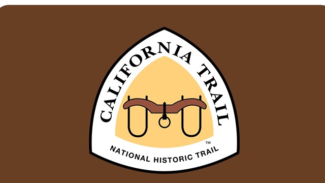 Brown sign, "California Trail Historic Route" with yellow triangle with logo.