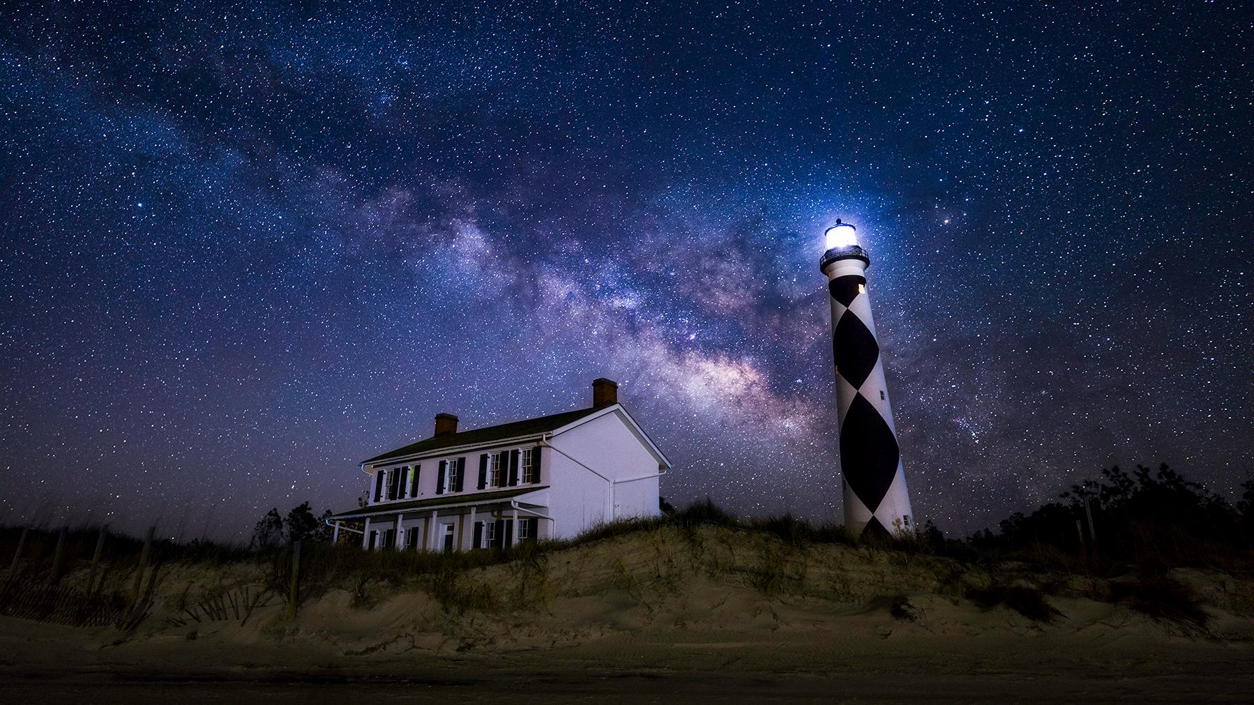 Milky Way arcs over the Cape Lookout Lighthouse and the Keepers' Quarters
