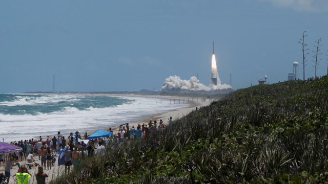 Visitors view a rocket launch.