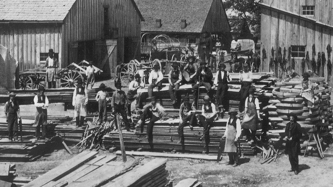 Civil War soldiers pose in the yard of the wagon and harness shops at Camp Nelson