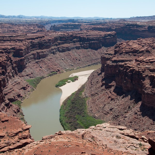 a river beneath tall canyon walls