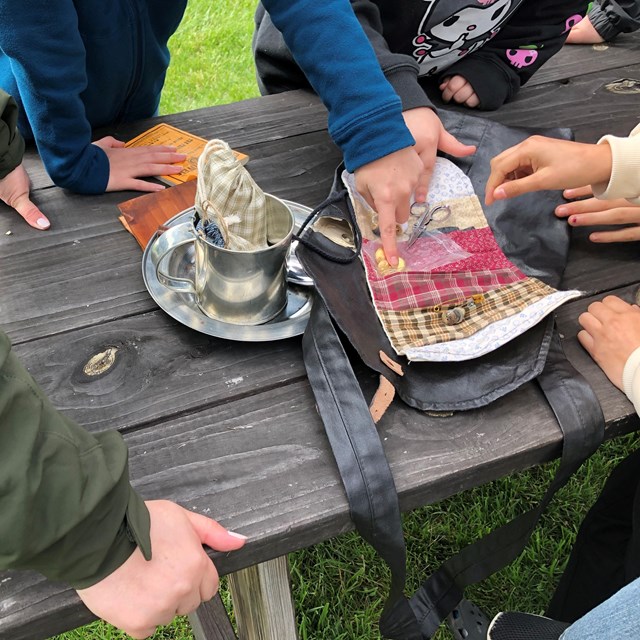 Children touch reproductions of Civil War soldiers
