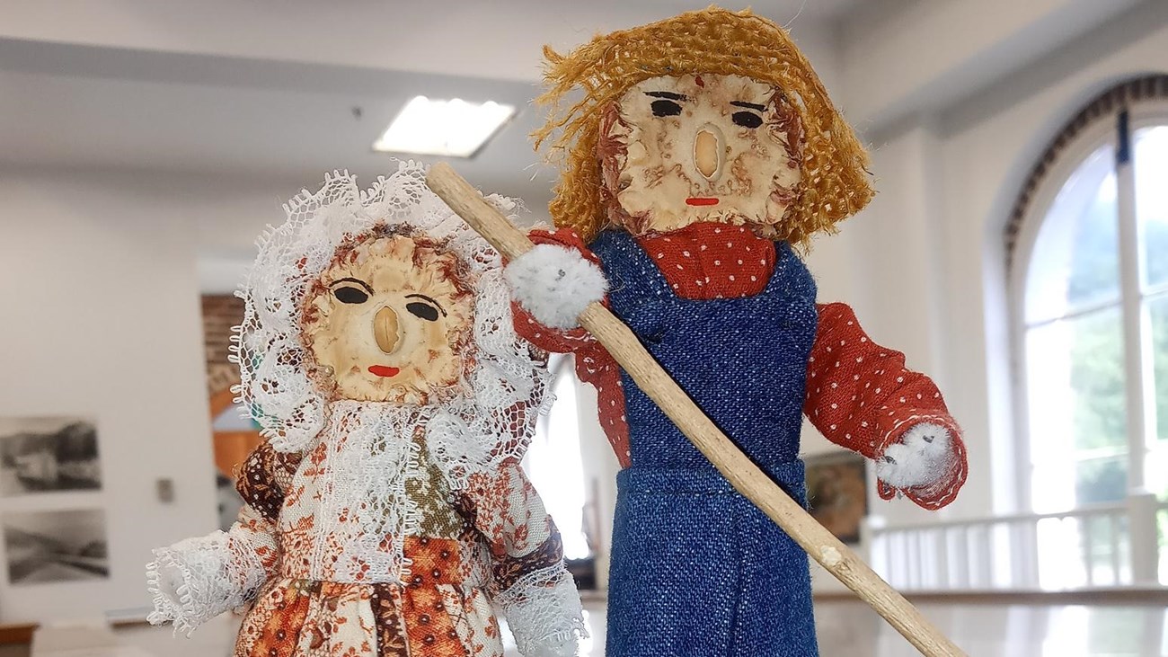 Two corn cob dolls, one woman and one man.