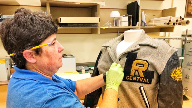 Central High School National Historic Site student volunteer works on a LRCH letter jacket from 1957