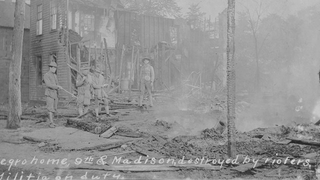 Historic black and white photo of a neighborhood in ruins