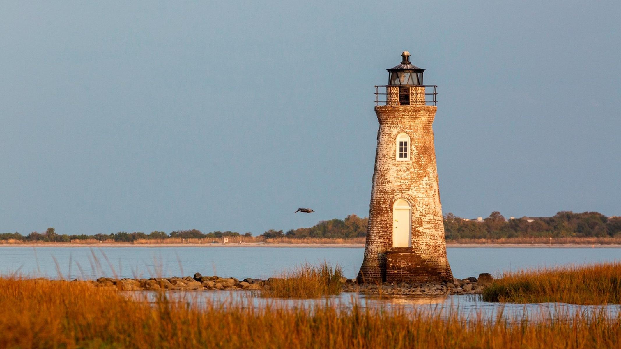 Red brick lighthouse in a wetland 