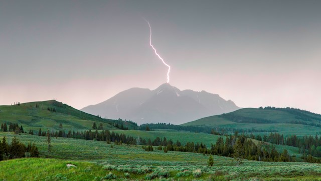 Lightning over a mountain and valley