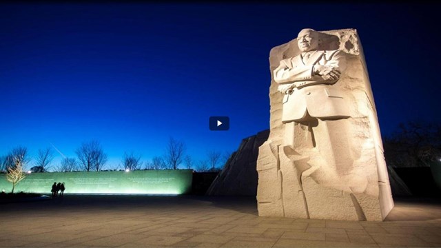 Video screenshot of a statue of Dr. Martin Luther King, Jr. at night