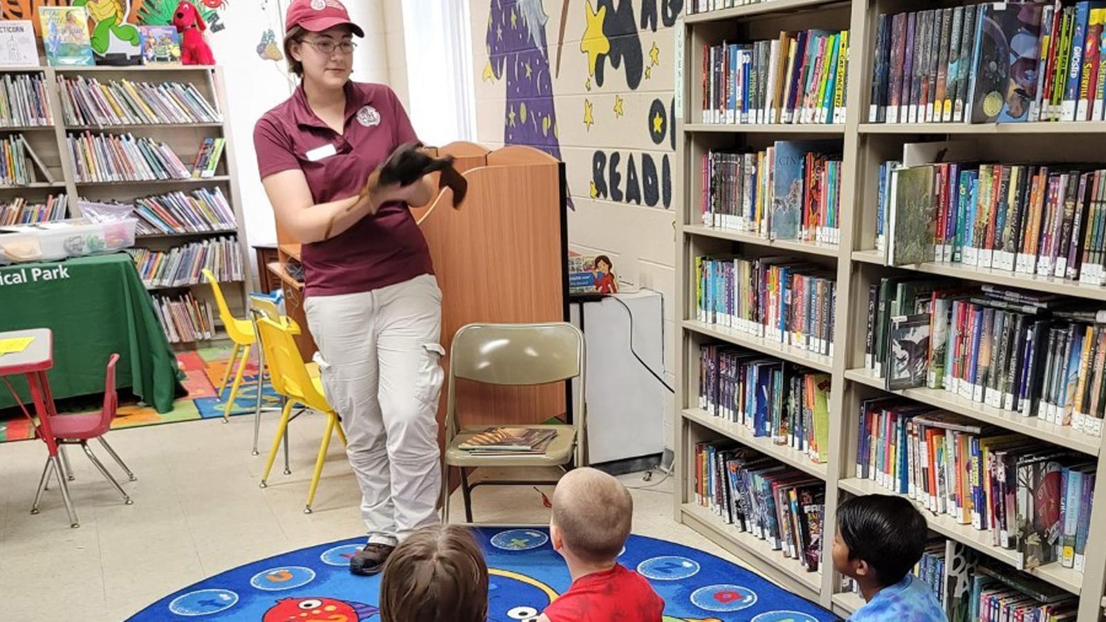 Library program woman teaching kids