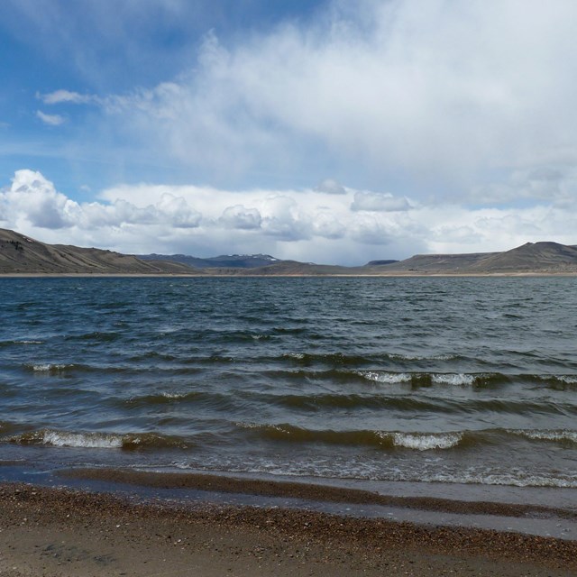 A reservoir with waves on a shore