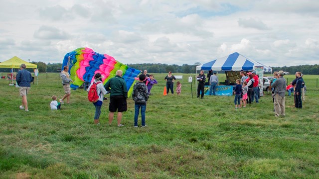 Visitors in a field during a park event