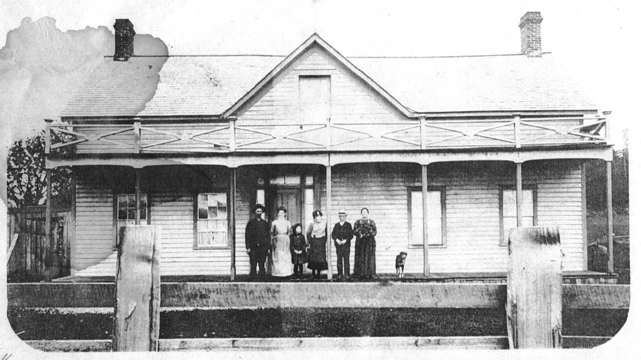 Historic photo of a family standing on the porch of the Ferry House