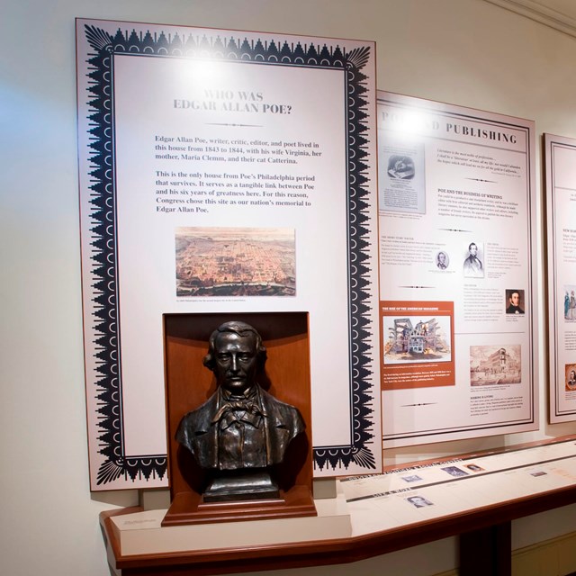 Color photo of an exhibit room with multiple exhibit panels and an image of Edgar Allan Poe.