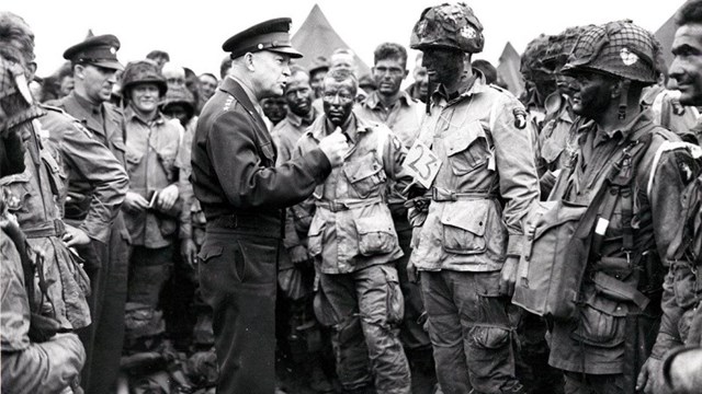 Black and white image of General Eisenhower speaking to paratroopers 