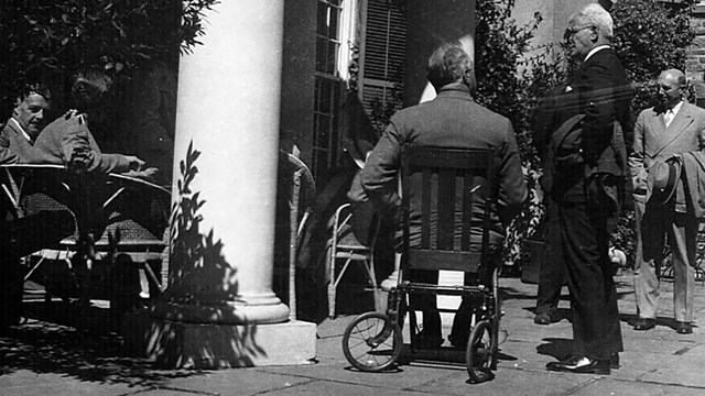 FDR seated in his wheelchair on a terrace.