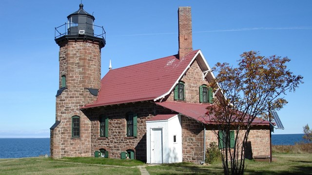 Stone house with a lighthouse tower attached