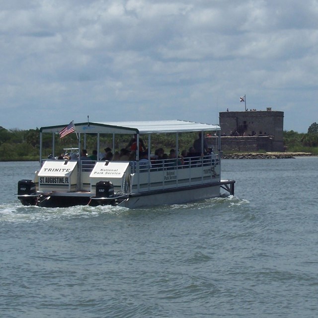 Profile of Fort Matanzas National Monument. Water in front and fort with cloudy sky in background.