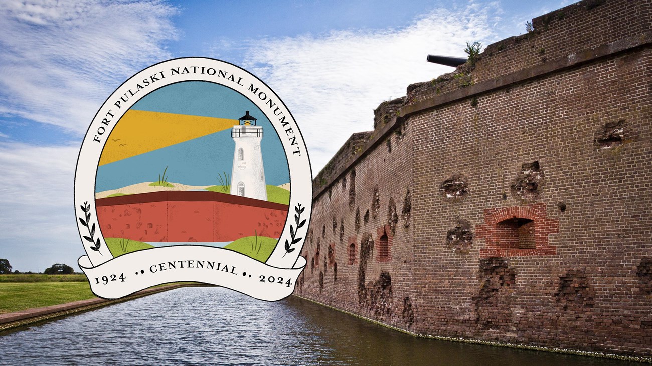 A brick building with a Fort Pulaski National Monument Centennial logo. 