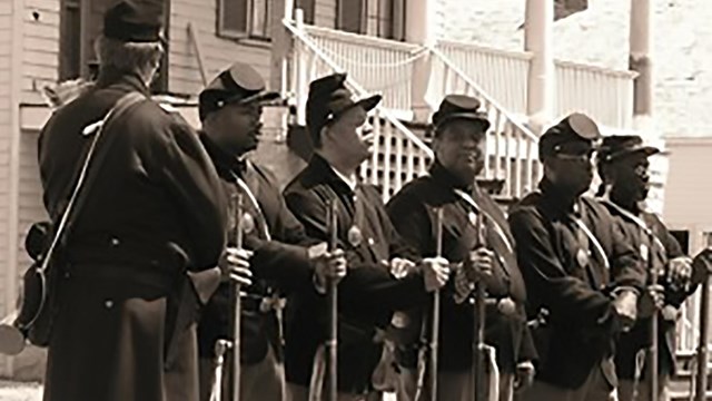 A group of 5 African-American reenactors as members of the 1st Kansas Colored infantry.