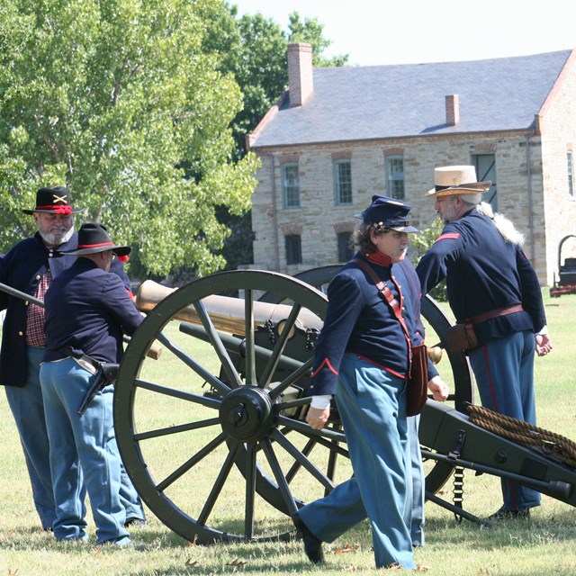 Union Civil War reenactors load a cannon.