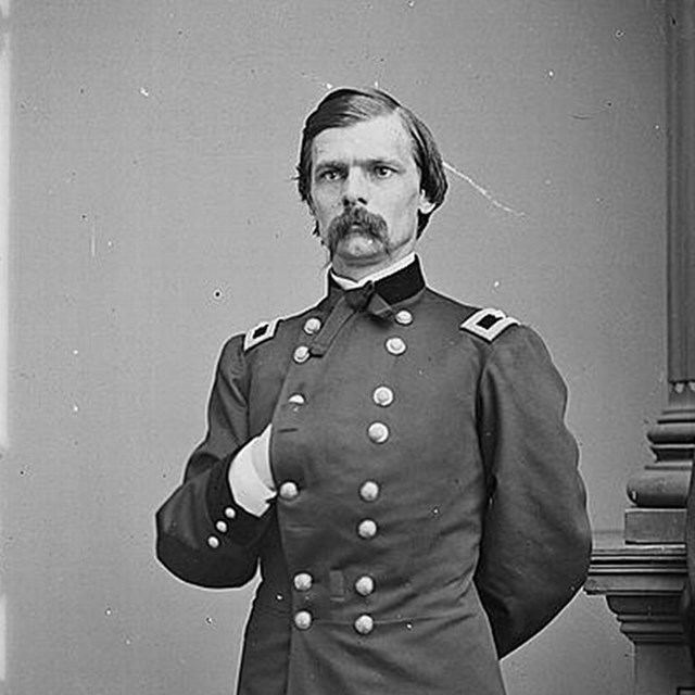 Photograph of George C. Strong standing with a Napoleonic pose, hand thrust inside jacket