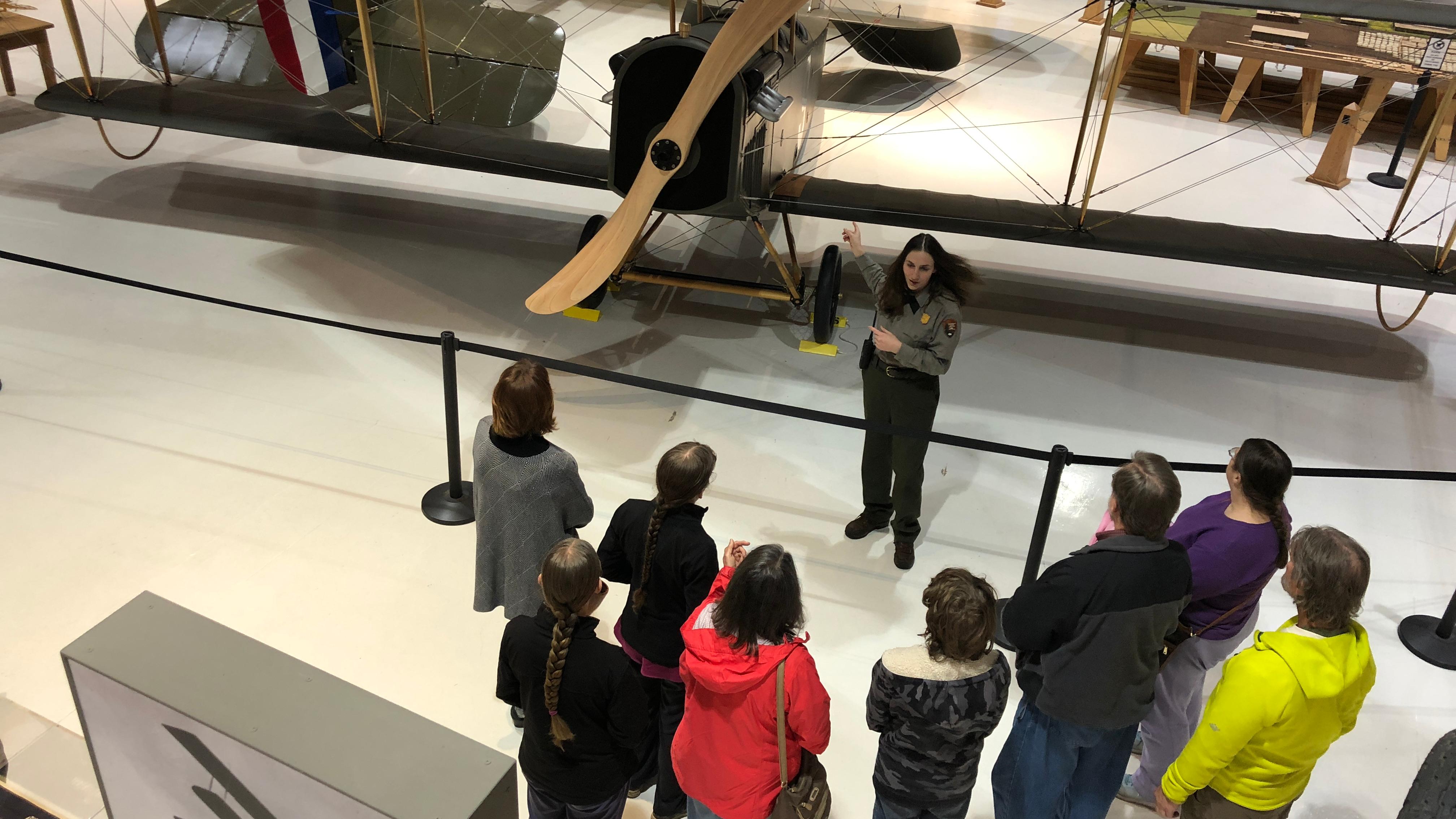A park ranger with a group of visitors inside Pearson Air Museum