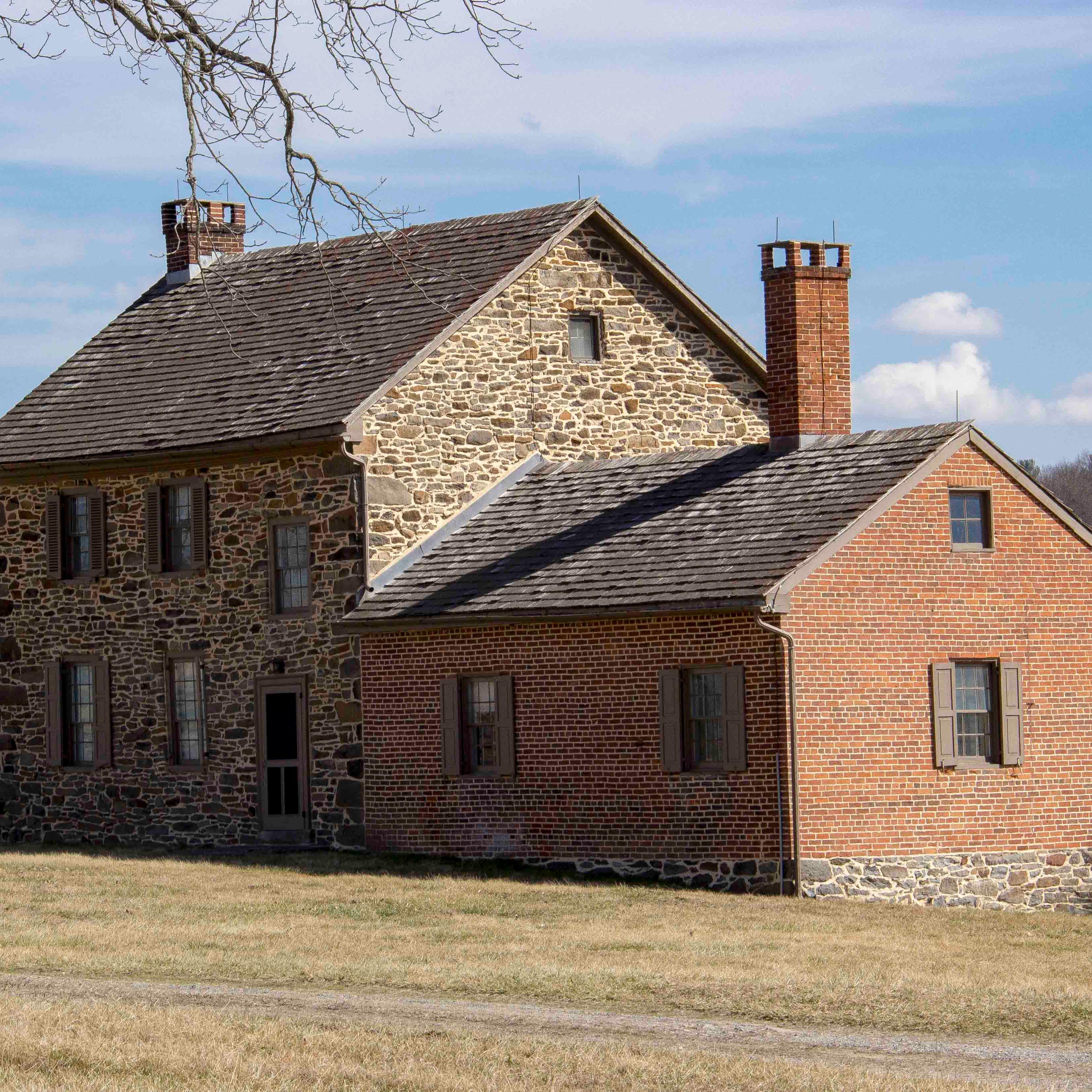 A photo of the Bushman House with Little Round Top in the background.