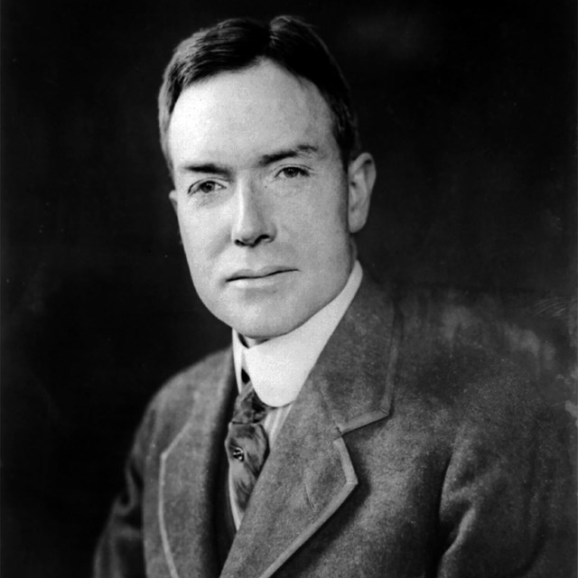 black and white photograph of a white male in a suit.