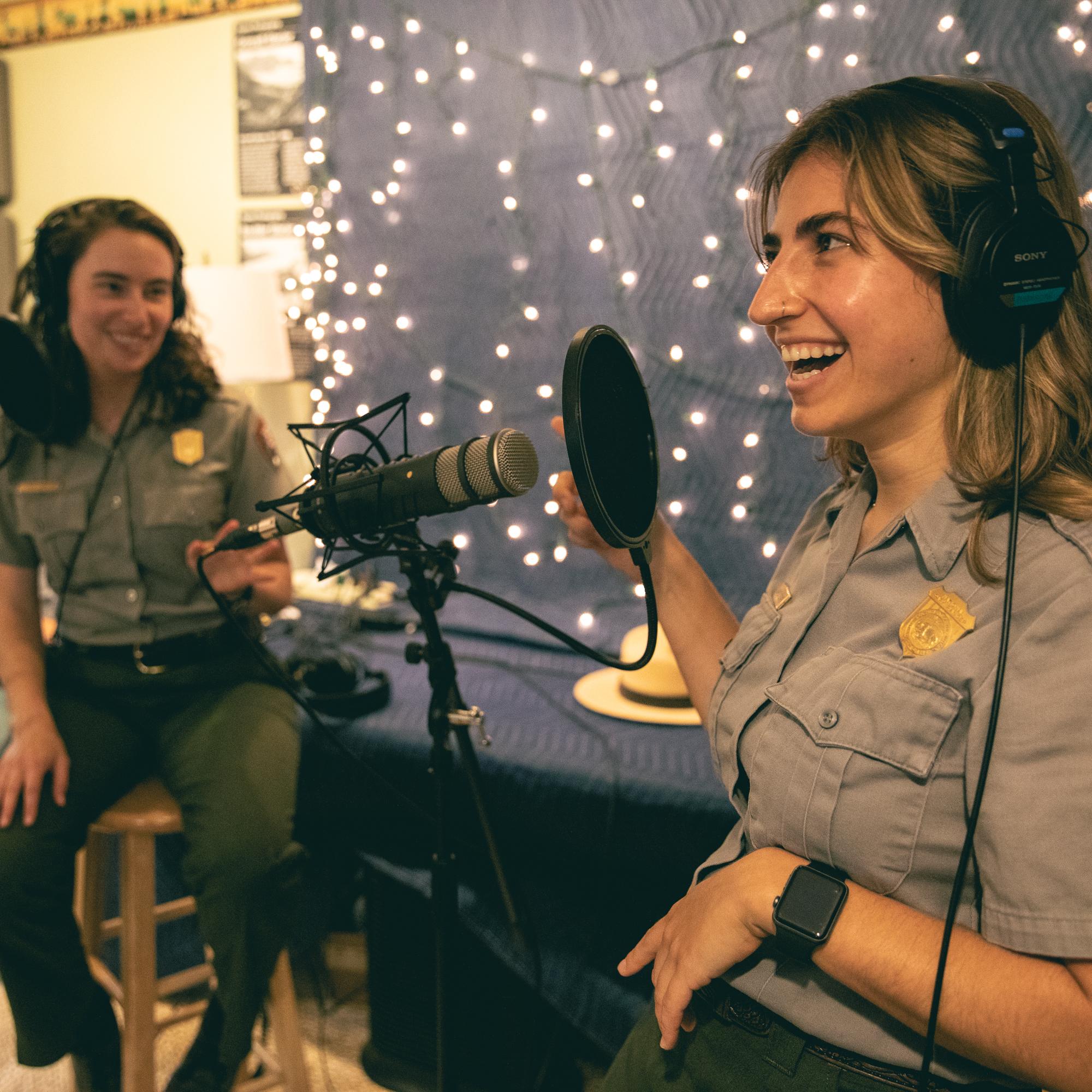 two park rangers talking into microphones