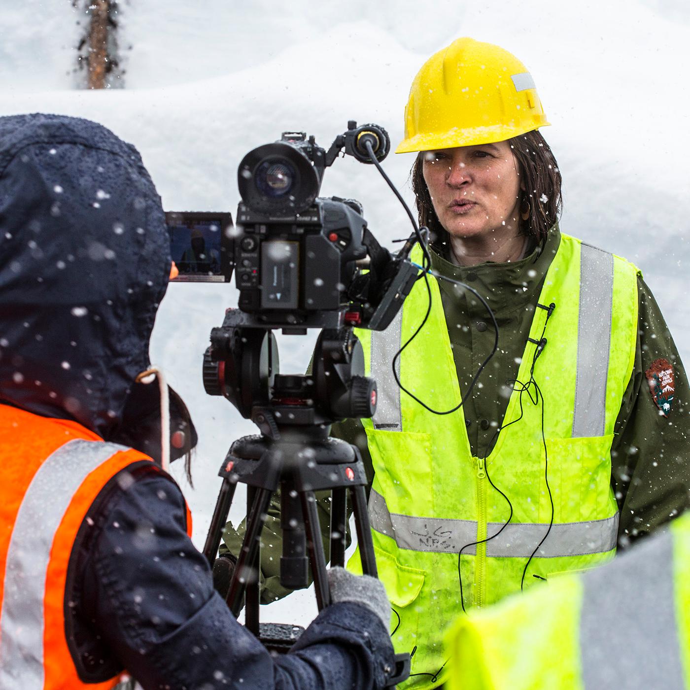 Park ranger giving an interview in front of the plowing operation