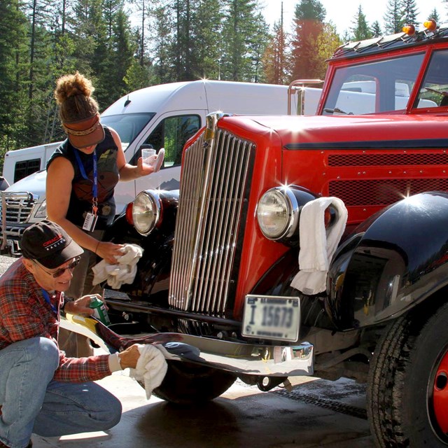 Employees wash historic red bus