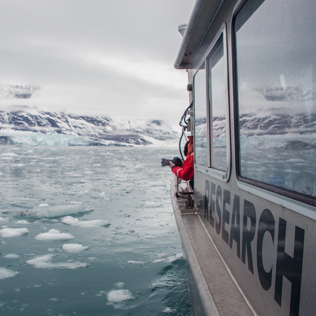 a research vessel in icy water near a tidewater glacier