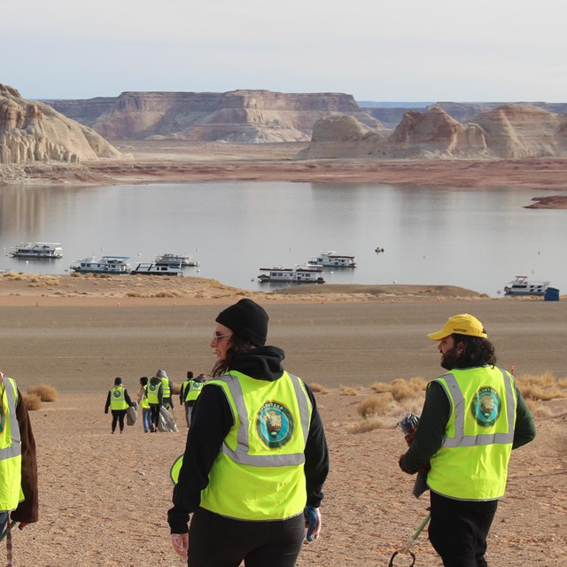 a group in safety vests picks up trash