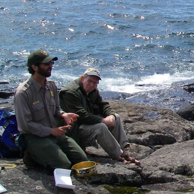 Park ranger talking to people on lakeshore