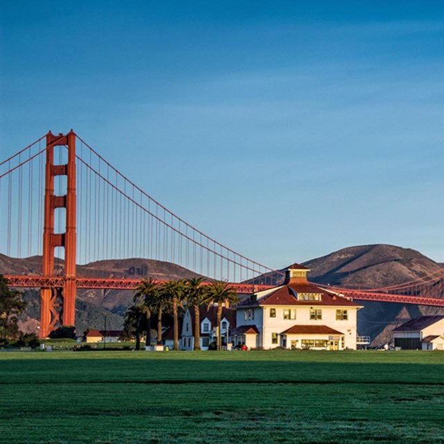 A white building with the Golden Gate Bridge in the background