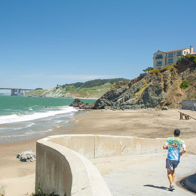 man jogging on trail leading to china beach shore