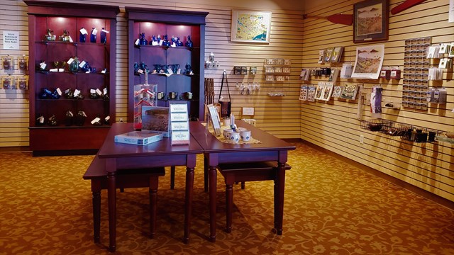 Interior view of tables and display racks with merchandise.