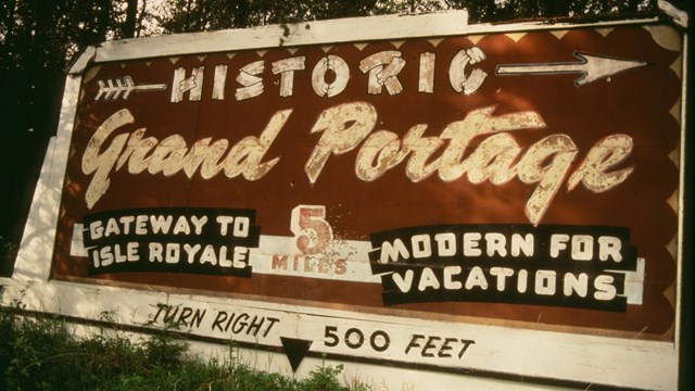 A historic brown and white sign.