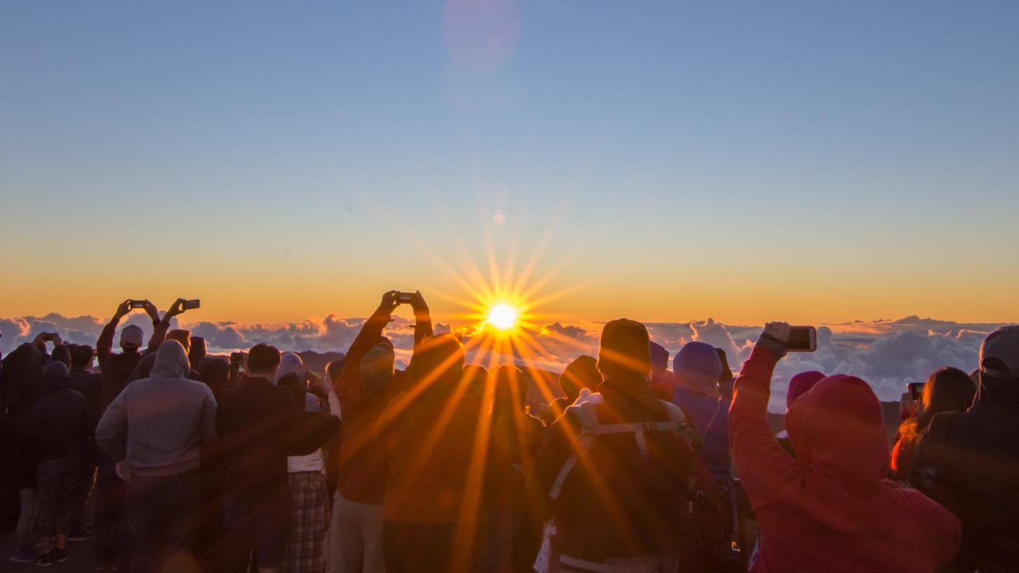 Visitors gather outside the visitor center to watch sunrise.