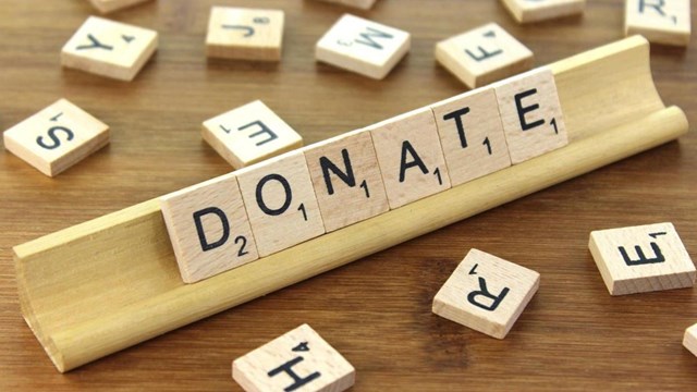 The word donation spelled in the game scrabble.