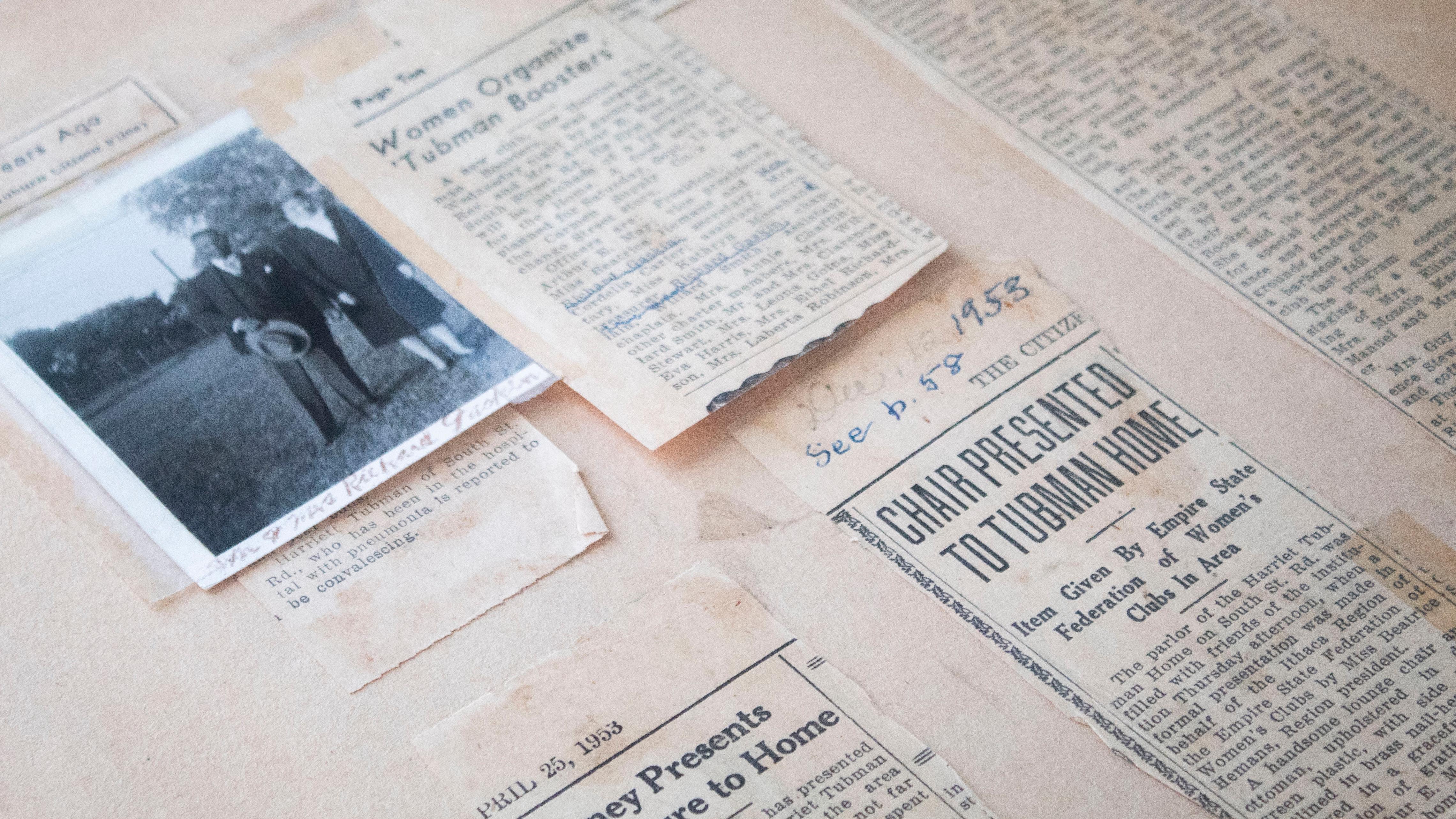 A scrapbook page with newspaper clippings and a small photograph