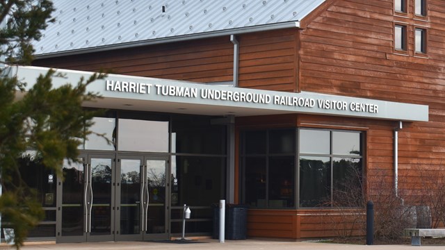 A wooden building with a sign that reads "Harriet Tubman Underground Railroad Visitor Center."
