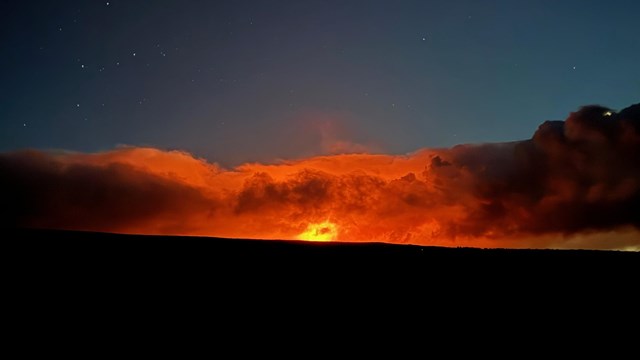 Red glow on horizon surrounded by darkness