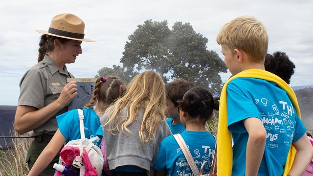 Ranger showing a group of students a model of the volcanic caldera. 