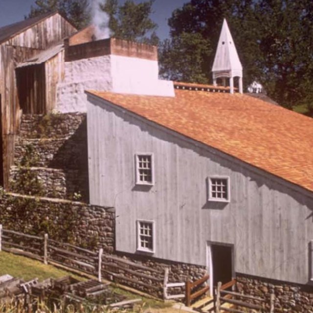 Large white and red building with a steeple. 