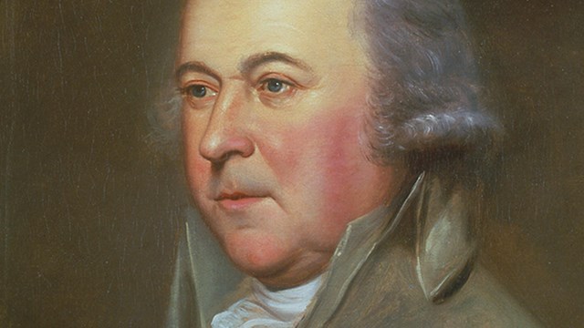 Color portrait of John Adams, showing gray-white hair and blue eyes.